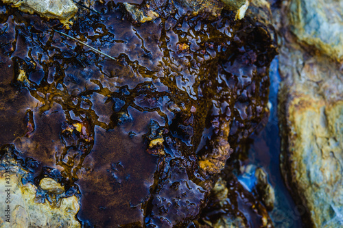Closeup shot of water running through the rocks at Rio Tinto mining park in Spain