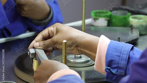 Two African women working on a diamond polishing machine photo