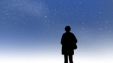 A person silhouette standng under a starry sky