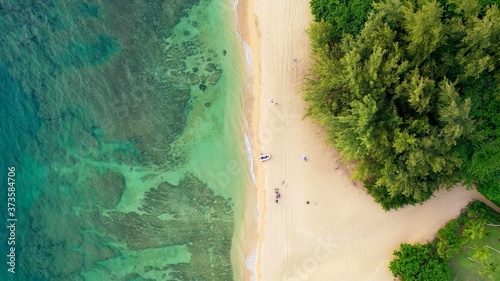 The aerian view of a beach of Hawaii with a white boat © Shenzen Photo Lab