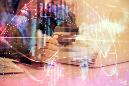 Multi exposure of woman on-line shopping holding a credit card and financial theme drawing. Business E-commerce concept.