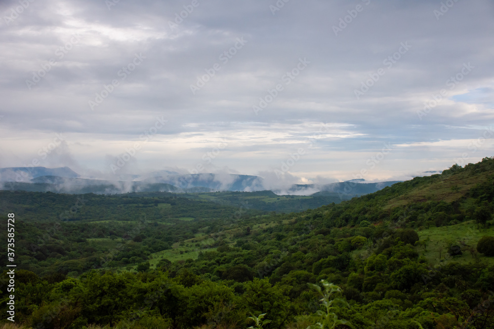 cloudy landscape of a green valley