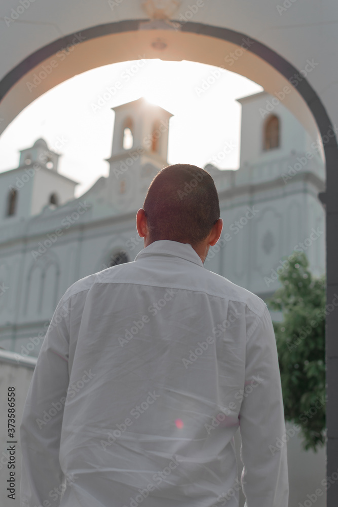 man looking at a church with hopes of a better tomorrow. man back man looking at a church with hopes of a better tomorrow. man back