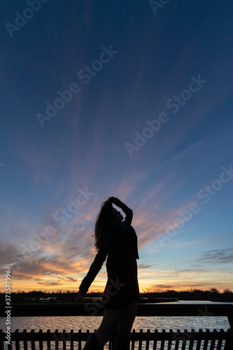 a young woman during a sunset
