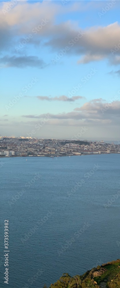 A statue of Cristo Rey and a view of the bridge named April 25 in Lisbon, Portugal.