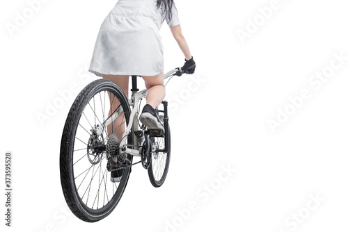 Fototapeta Naklejka Na Ścianę i Meble -  Rear view of a woman riding a bicycle