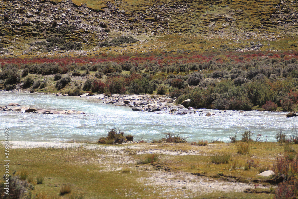 View of mountains and stream of melting snow in Tibet, China