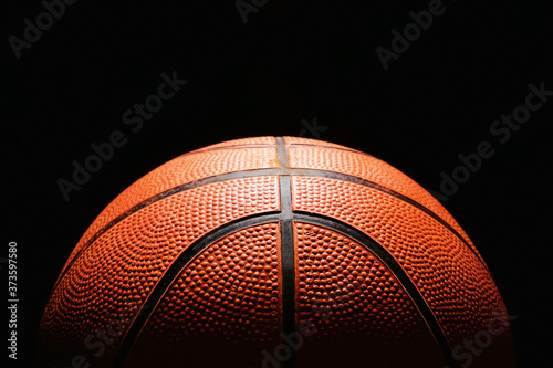 Ball for playing basketball on dark background, closeup