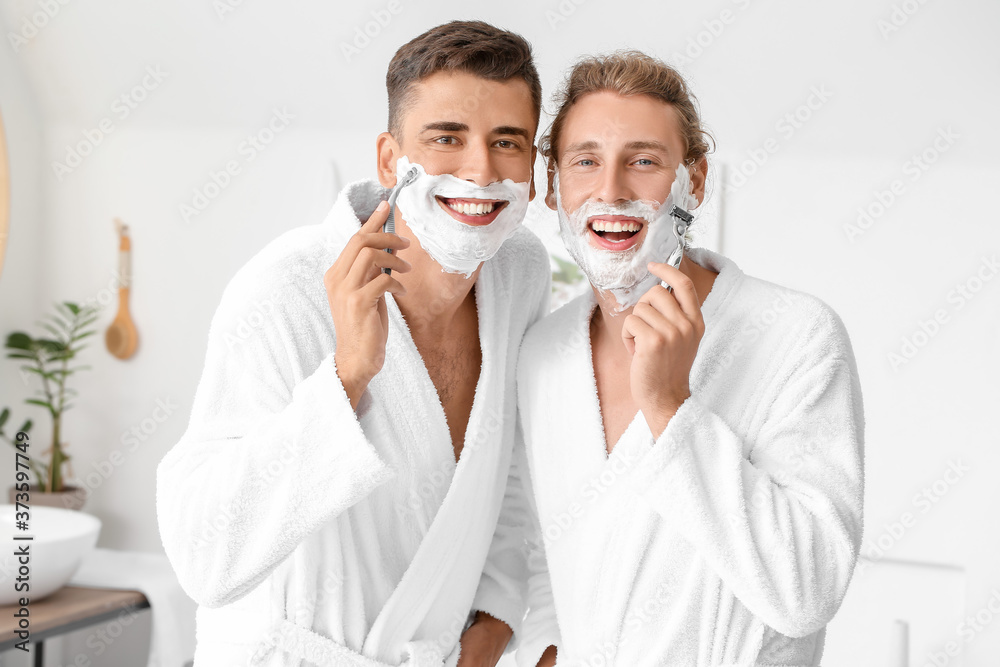Happy gay couple shaving in bathroom