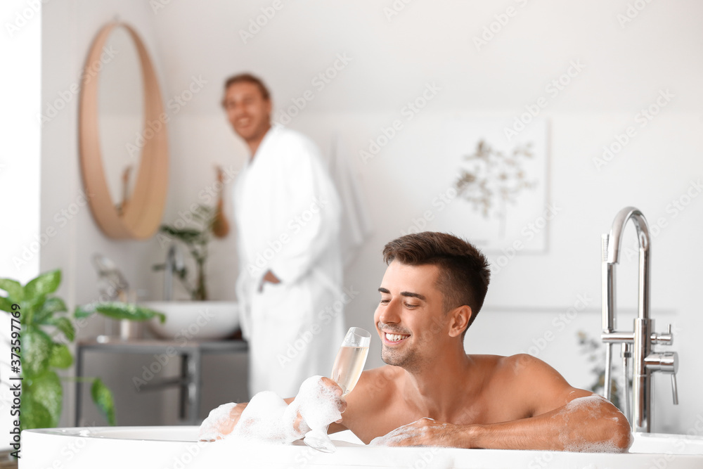 Happy gay couple spending time in bathroom Happy gay couple spending time in bathroom