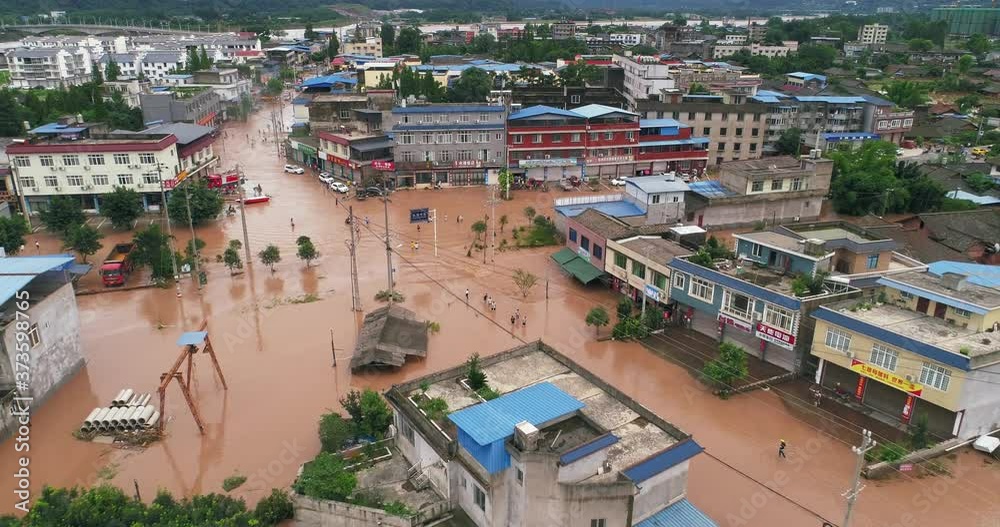 Aerial view of small town been flood Flooded Chinese neighbourhood in Leshan Sichuan China at 2020 Homes, houses overflowing water people walking in the water car driving in flood