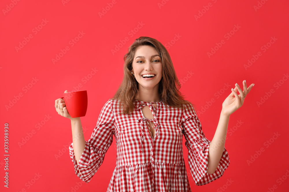 Beautiful young woman with cup of tea on color background Beautiful young woman with cup of tea on color background