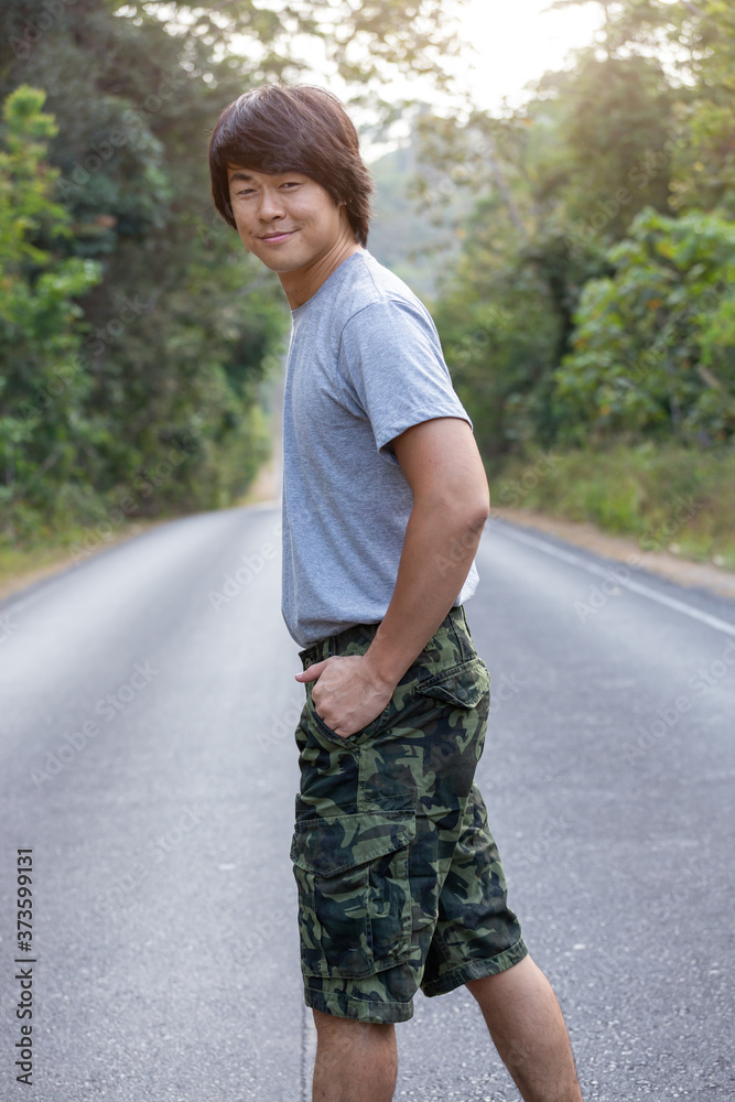 Asia man in bermuda shorts and t-shirt, outdoor activity concept Asia man in bermuda shorts and t-shirt, outdoor activity concept