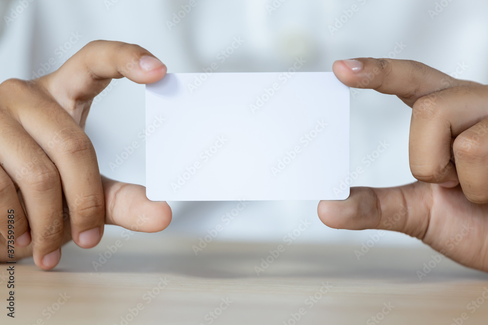 Hand holding the empty white card Hand holding the empty white card