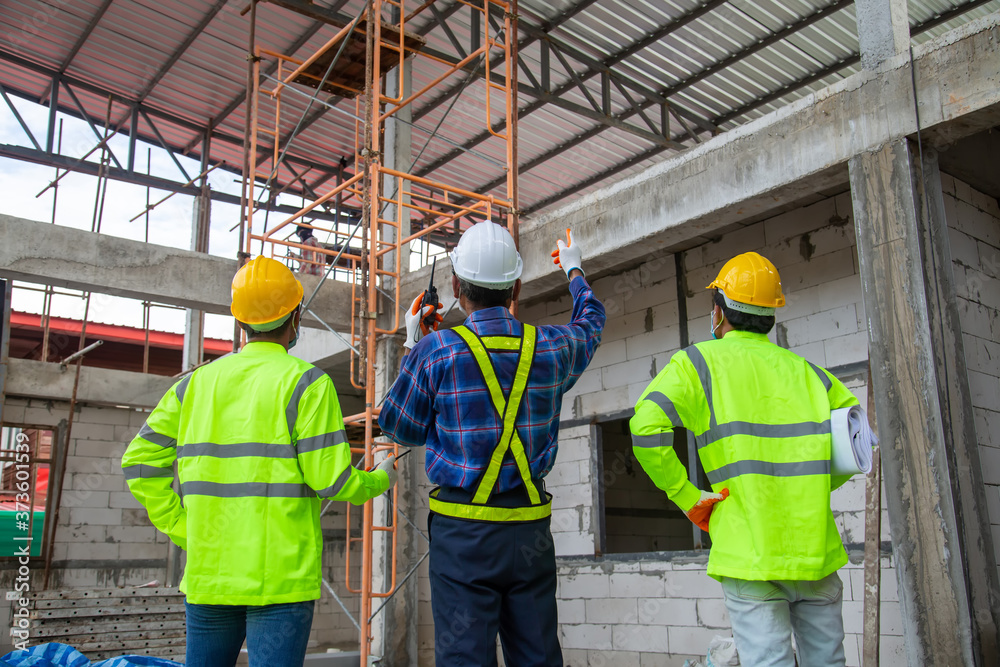 Asian engineer technician team inspector of workers to productivity build a house in the construction site Asian engineer technician team inspector of workers to productivity build a house in the construction site
