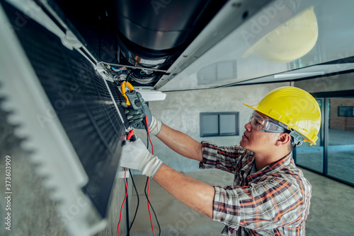 Technician - Engineer investigate Repairing Air Conditioner photo