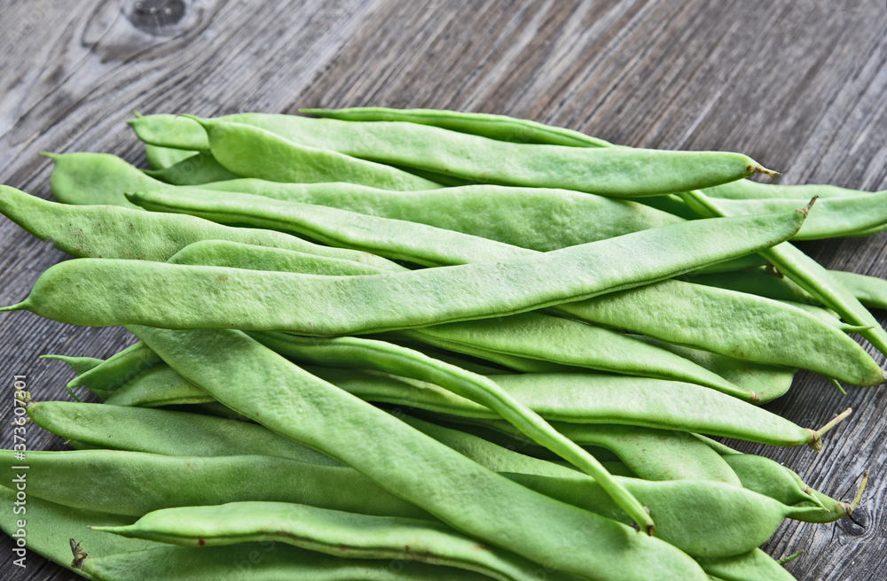 Fresh Roma II Italian Bush Bean or Romano Pole Bean (Phaseolus vulgaris) on wooden background. Fresh Roma II Italian Bush Bean or Romano Pole Bean (Phaseolus vulgaris) on wooden background.