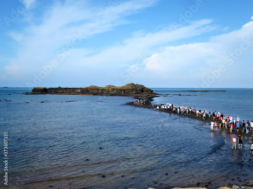 Visitors walk a underwater pathway known as the “Moses Parts the Sea” (奎壁山摩西分海) in Penghu County, TAIWAN