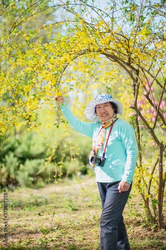 Portrait of happy senior beautiful woman in spring park  © moli