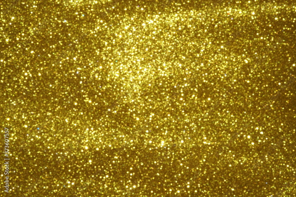 gold Sparkling Lights Festive background with texture. Abstract Christmas twinkled bright bokeh defocused and Falling stars. Winter Card or invitation	