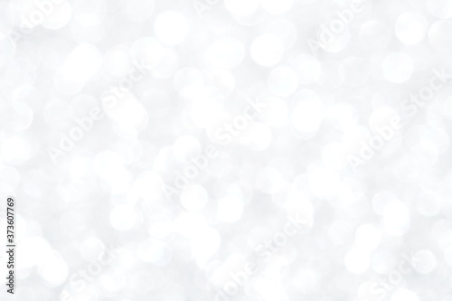 Silver Sparkling Lights Festive background with texture. Abstract Christmas twinkled bright bokeh defocused and Falling stars. Winter Card or invitation	