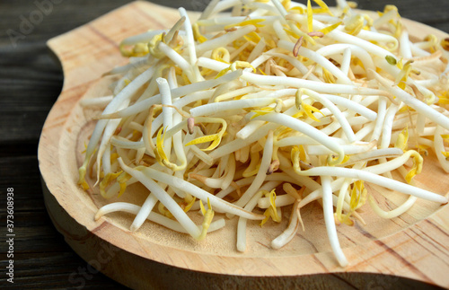 Fresh bean sprout or the sprout of mung bean in wooden tray on wooden background.