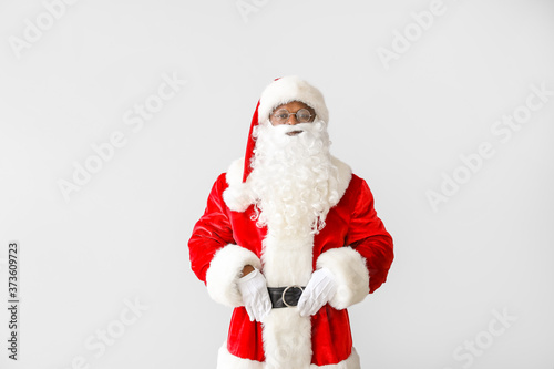 African-American Santa Claus on light background © Pixel-Shot