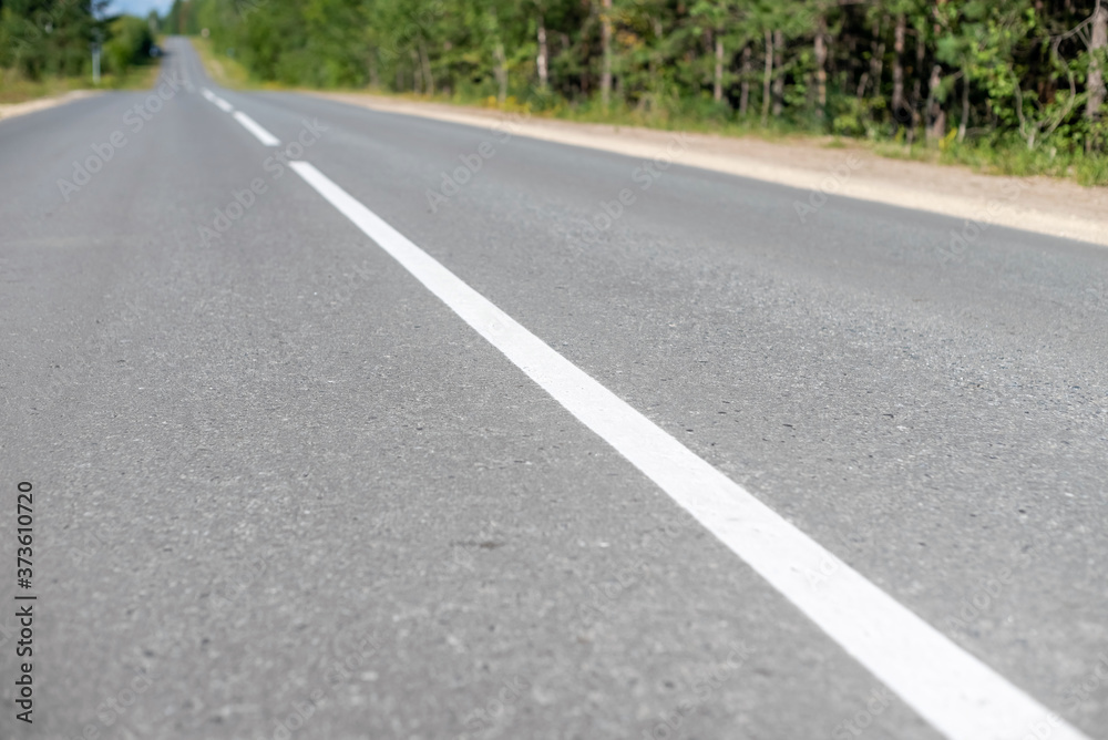 White dividing line on the asphalt road.