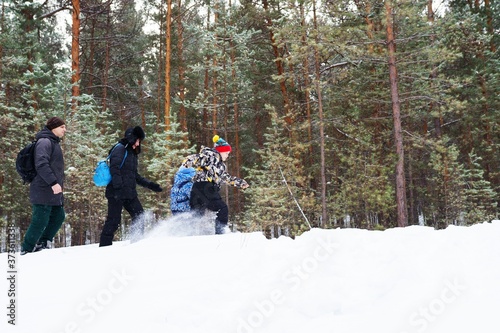 Family walking in winter forest