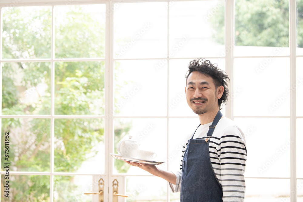 お洒落なカフェのヒゲの中年男性店員 Stock Photo Adobe Stock