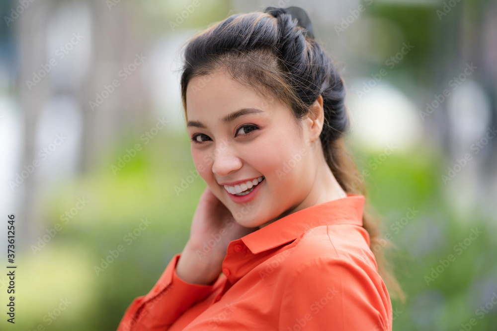 Outdoors portrait of Happy young woman with smiley face Outdoors portrait of Happy young woman with smiley face