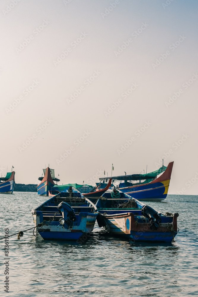 Fototapeta premium Beautiful view of boats tied in Calicut fish harbor in the evening.