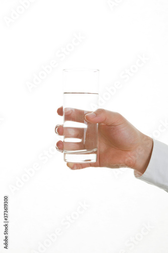 hand holding glass of water on white background