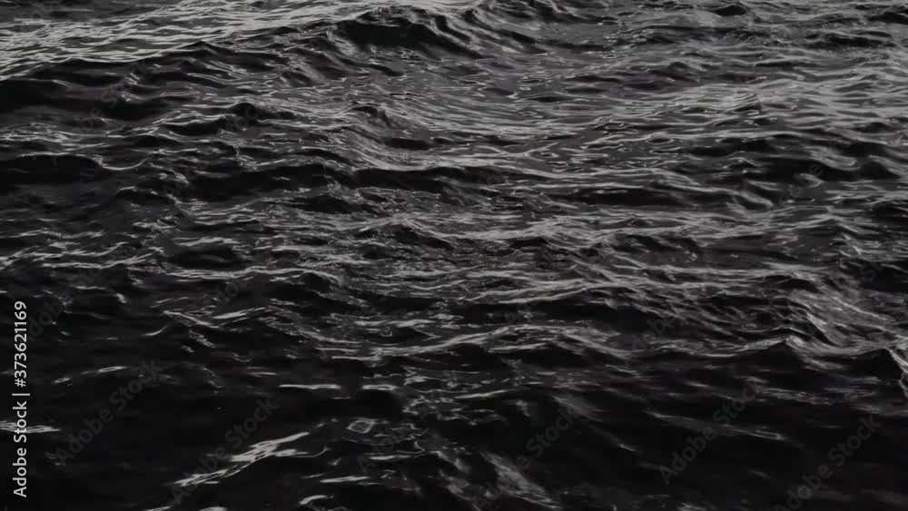 Sun glare on the water. Natural background with sun glints on surface of water. Never endless sea water surface view and sun blaze. Texture of water surface of sea reflection of sun's rays