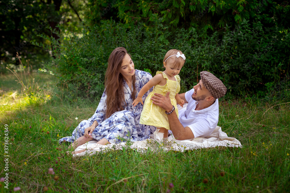 happy young family plays with their liitle baby daughter at the green meadow happy young family plays with their liitle baby daughter at the green meadow