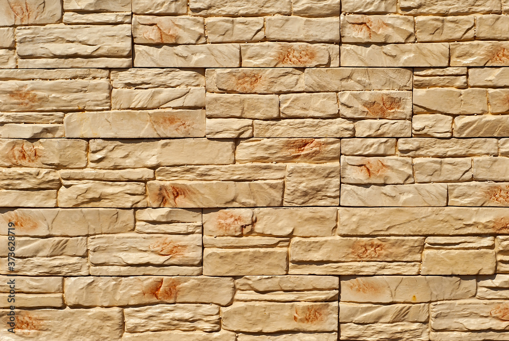 Fototapeta premium Texture of brick wall and concrete blocks. Samples of stone plates stacked evenly in a row.