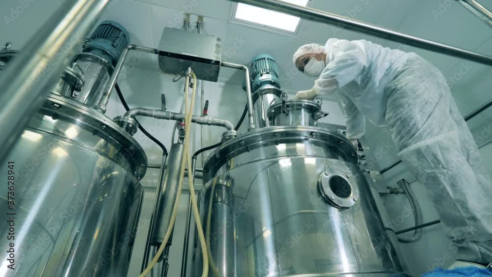 Pharmacology specialist is working with chemical reactors
