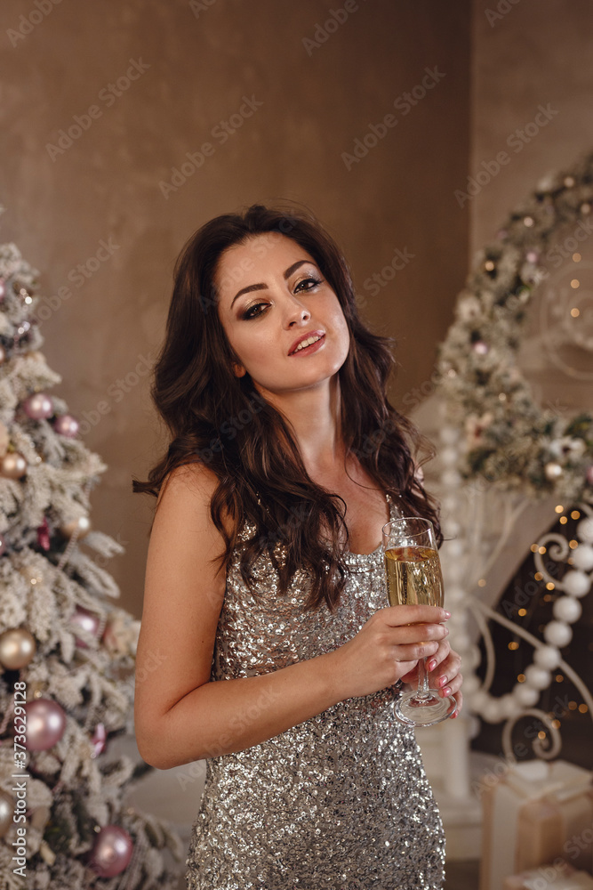 smiling woman in dress over christmas tree background