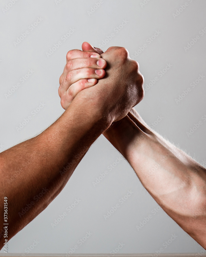 Rivalry, closeup of male arm wrestling. Muscular men measuring forces