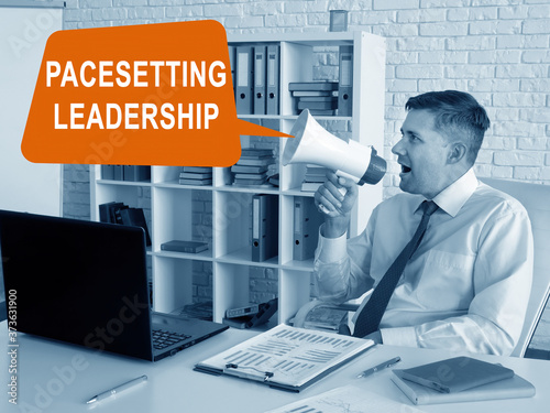 Pacesetting leadership concept. Manager with loudspeaker in the office. photo