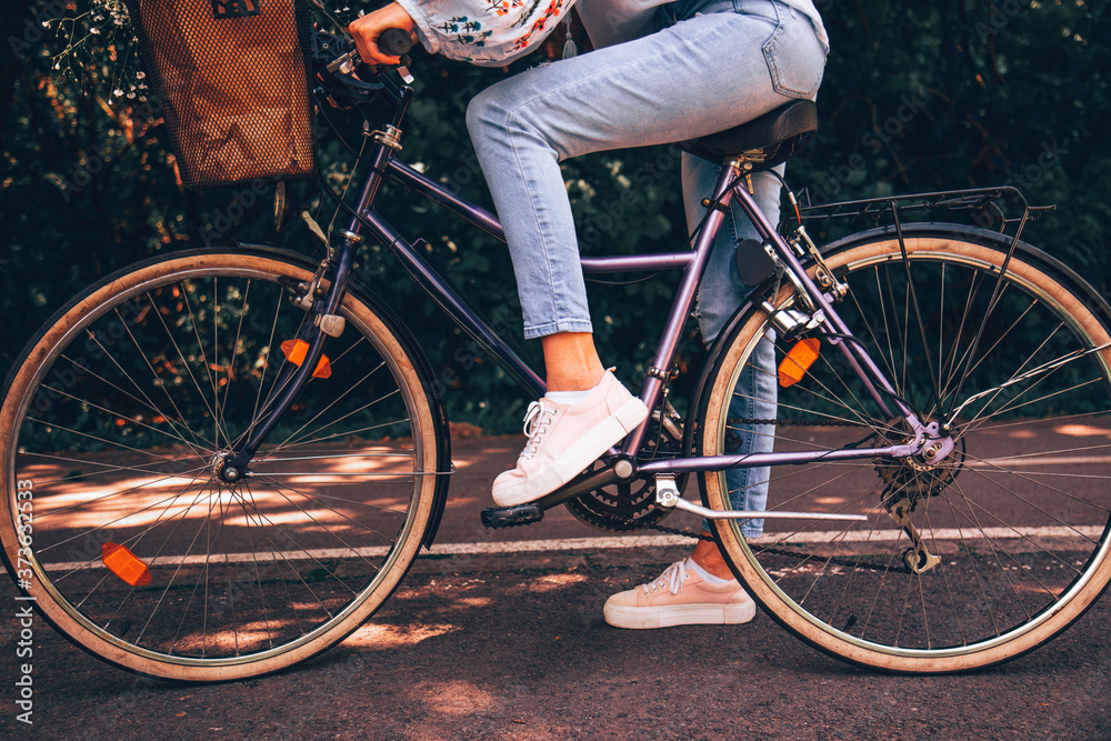 Naklejka premium Attractive beautiful woman riding a bicycle in nature.
