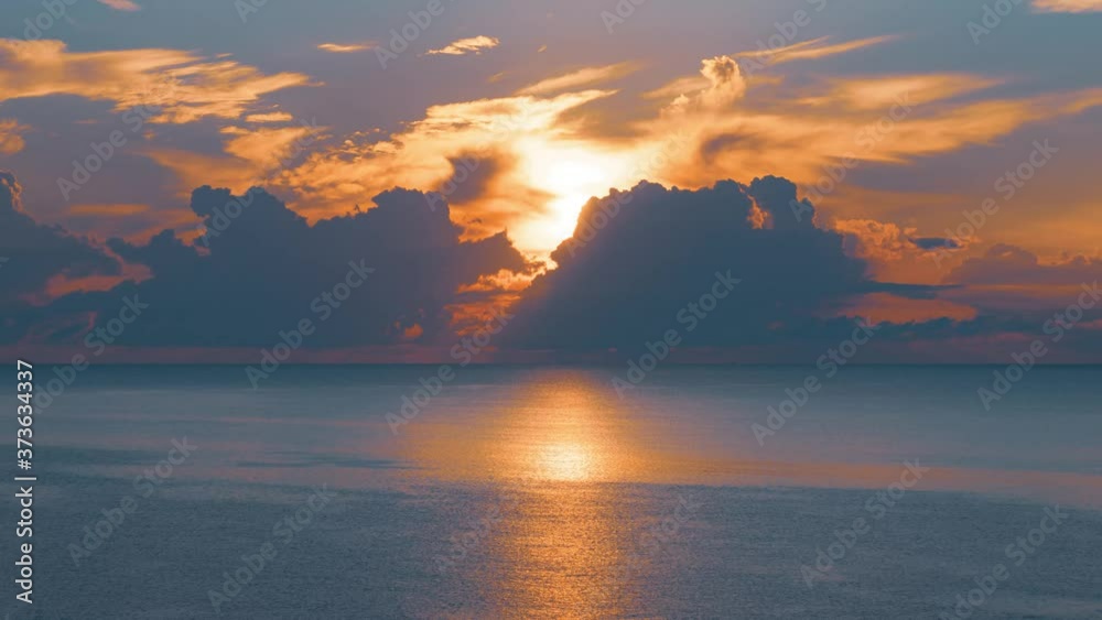 Sun rising from the sea. Colorful cloudy sky and sunbeams. 4k time lapse Sun rising from the sea. Colorful cloudy sky and sunbeams. 4k time lapse