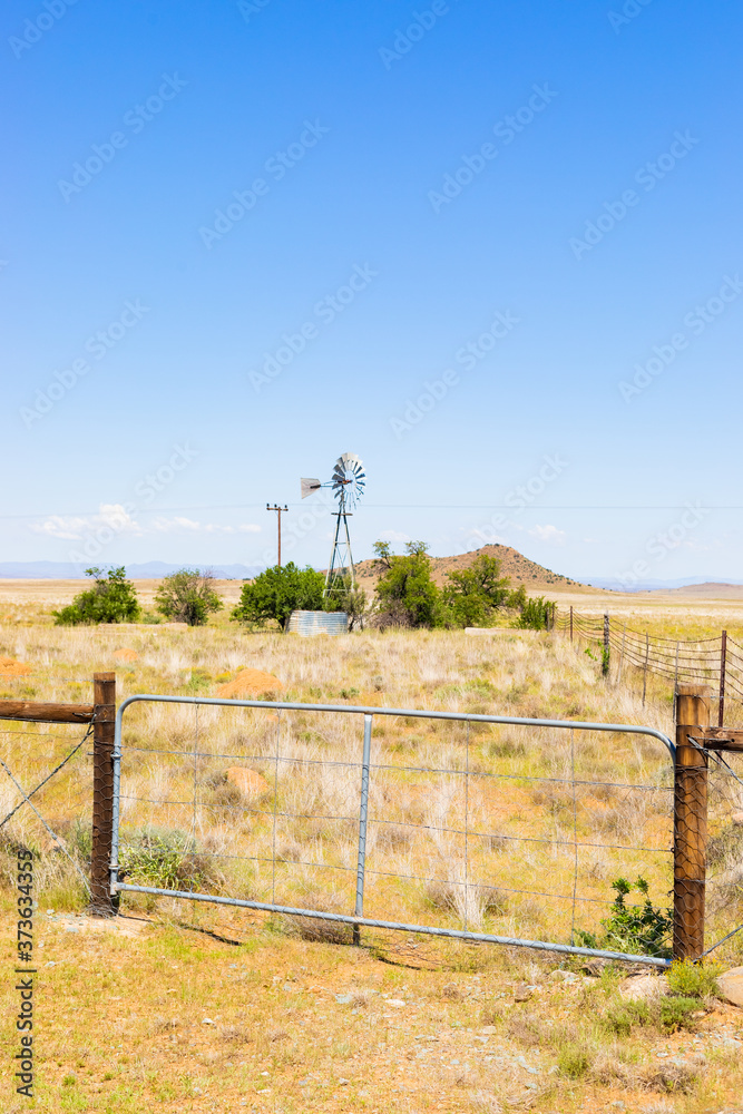 Windmill on a farm in rural grassland area of South Africa