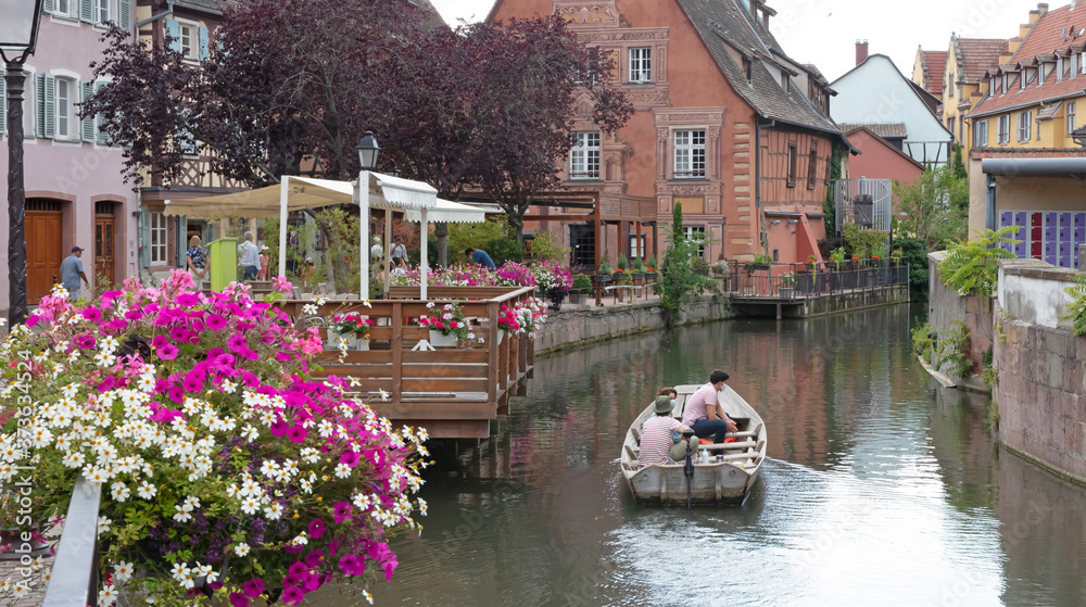 Obraz premium Colmar, France on july 20, 2020; Petite Venice, water canal and traditional half timbered houses. Colmar is a charming town in Alsace, France.