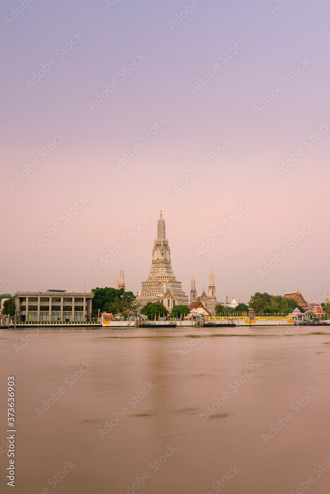 Wat Arun and Chao Phraya river in Bangkok, Thailand at dawn