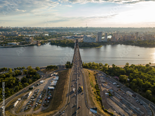 Aerial drone view. Cars travel along the North Bridge across the Dnieper in Kiev. © Sergey