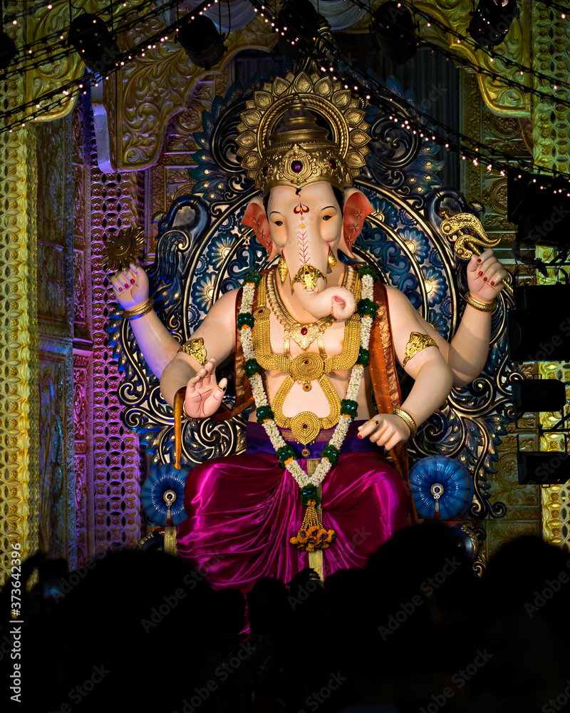 Closeup , portrait view of decorated and garlanded idol of Hindu God Ganesha.