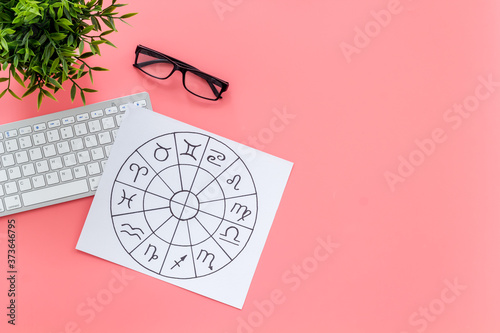 Fotografi Top view of horoscopic wheel with Zodiac signs on work table