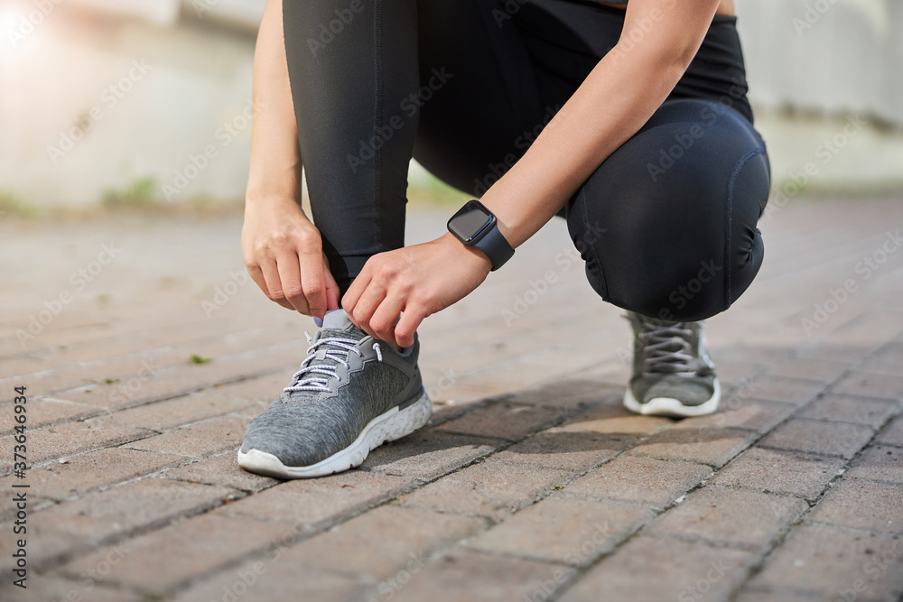 Close up of female hands tying shoelaces