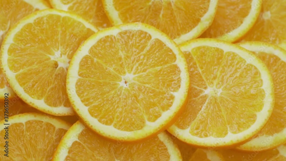Round Fresh Juicy Sliced Yellow Orange Citrus Slices Rotate, Macro. The Concept of a Healthy Diet and the Use of Vitamin C to Strengthen the Immune System Round Fresh Juicy Sliced Yellow Orange Citrus Slices Rotate, Macro. The Concept of a Healthy Diet and the Use of Vitamin C to Strengthen the Immune System